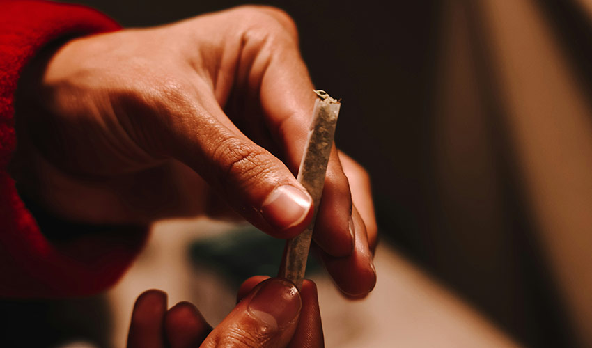 Person holding joints in their hand