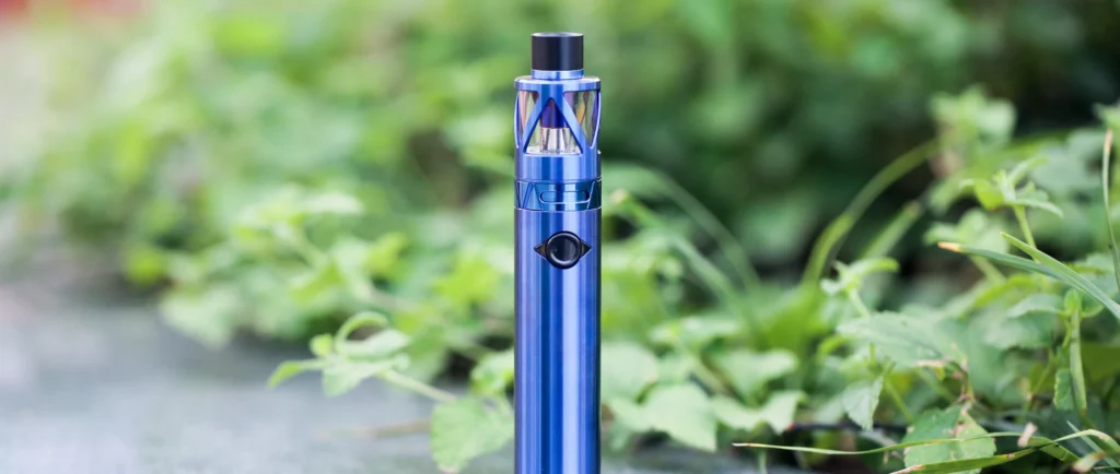 Blue electronic cigarette on the ground highlighting its sleek, modern design