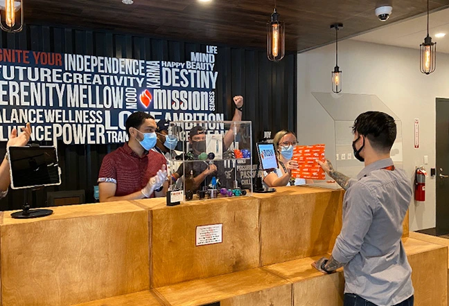 Customer at Mission Dispensary checkout counter