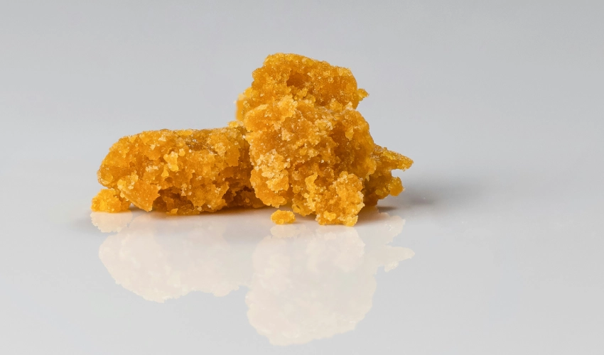 Glass-like cannabis concentrate with golden amber color