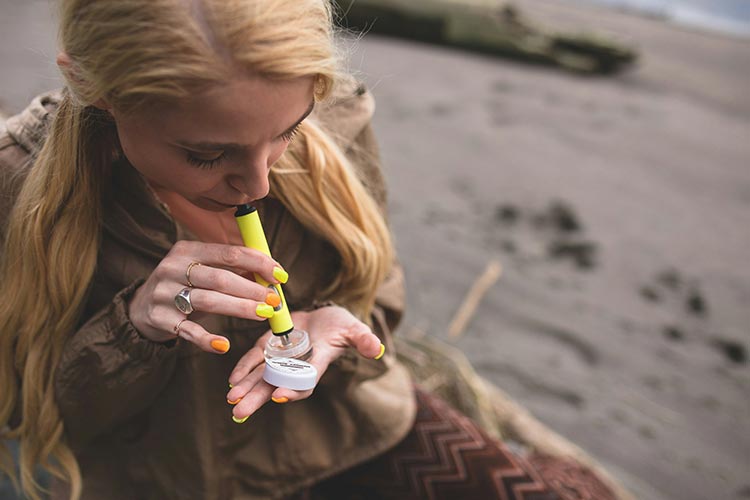 Person vaporizing wax concentrate