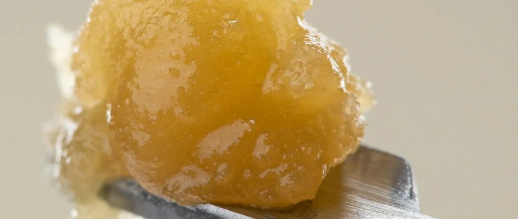 Small golden resin-like piece on a textured surface